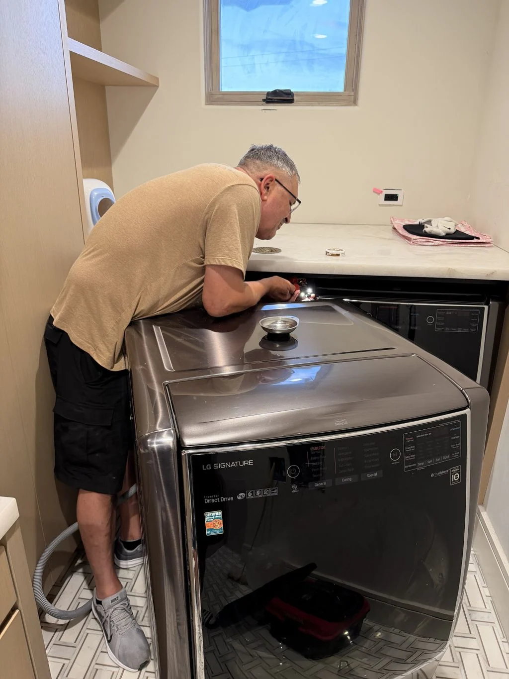 Extory technician servicing an LG Signature washing machine
